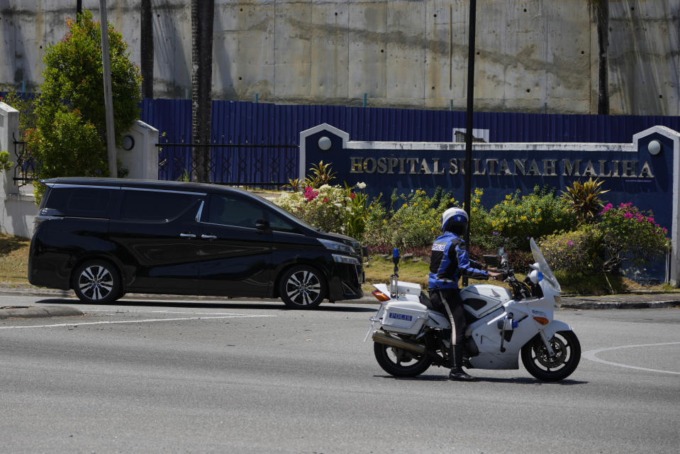 A police outrider escorts a vehicle with a diplomatic license plate entering Sultanah Maliha Hospital compound, where Norway's King Harald is believed to have been admitted with an infection, on the Malaysian resort island of Langkawi, Malaysia, Thursday, Feb. 29, 2024. Malaysian national news agency Bernama cited unnamed sources as saying he was staying in the hospital’s Royal Suite. (AP Photo/Vincent Thian)