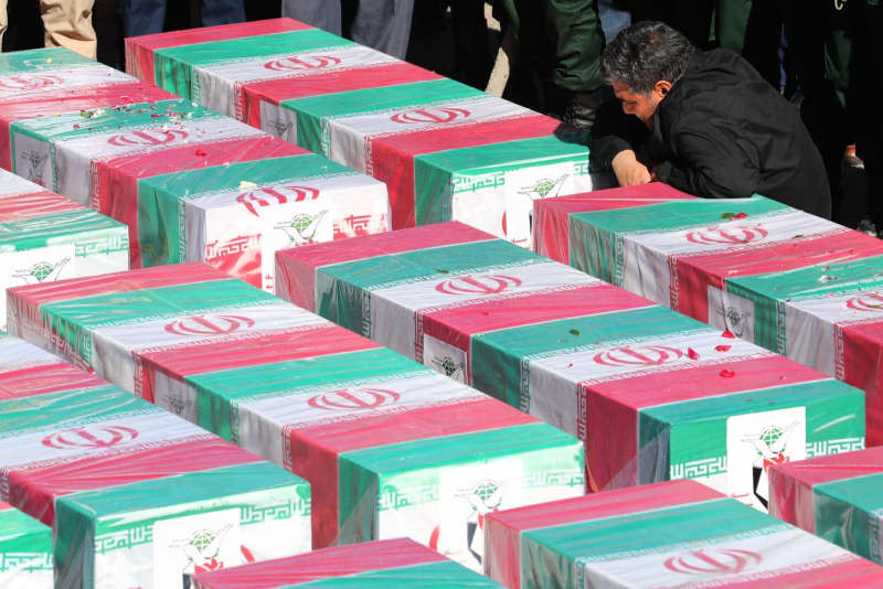 A man mourns next to the coffins during a funeral ceremony for the victims of the recent explosions that struck a crowd commemorating Iranian top commander Soleimani, at the Saheb al-Zaman mosque. On the 4th anniversary of the assassination of Iranian General Soleimani, two explosions killed more than 70 people and wounded another 171 near the mausoleum dedicated to him. Iranian Presidency/ZUMA Press Wire/dpa