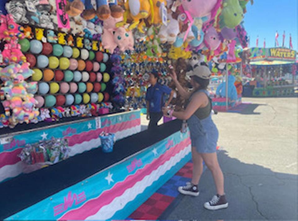 A Sacramento Bee reporter plays a carnival game at the California State Fair in 2023. The fair kicks off at Cal Expo in Sacramento on Friday, July 12, 2024.