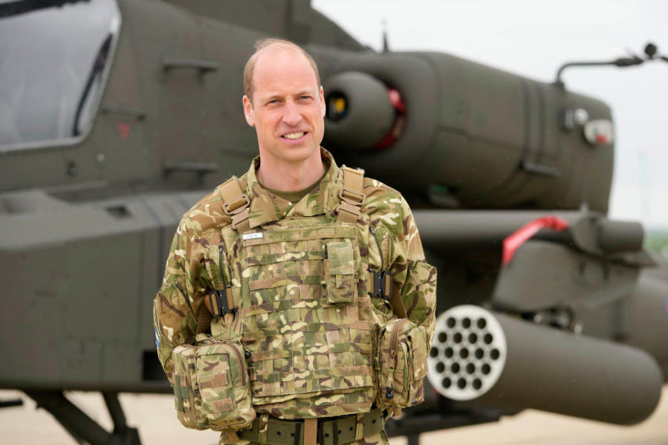 STOCKBRIDGE, UNITED KINGDOM - MAY 13: Prince William, Prince of Wales stands in front of an Apache helicopter at the Army Aviation Centre in Middle Wallop, on May 13, 2024 in Stockbridge, Hampshire. (Photo by Kin Cheung - WPA Pool/Getty Images)