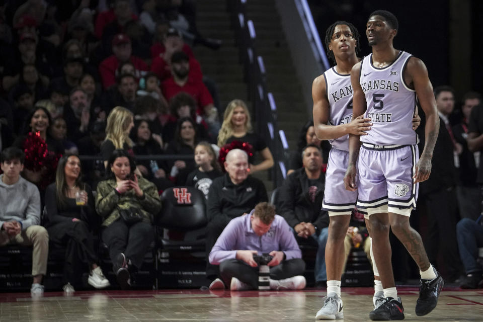 Kansas State guard Dai Dai Ames (4) and guard Cam Carter (5) watch a replay after Carter got another foul during the second half of an NCAA college basketball game against Houston, Saturday, Jan. 27, 2024, in Houston. (Jon Shapley/Houston Chronicle via AP)