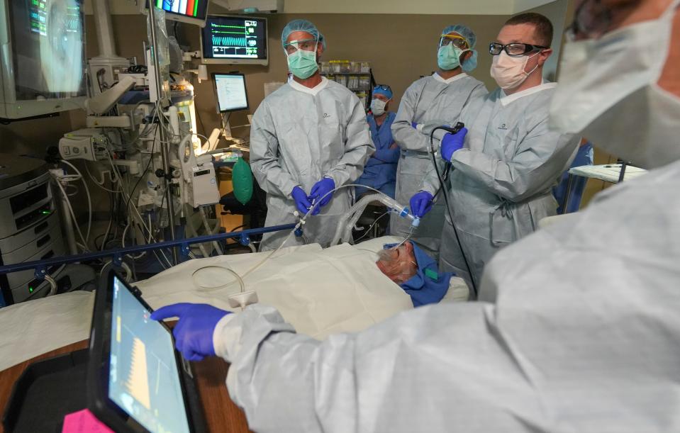Dr. Jonathan Kurman, middle right, looks views Roger Rose's airways prior to performing the Emphysema procedure Tuesday, Aug. 2, 2022, at the Center for Advanced Care, Froedtert Hospital Campus at 8900 W. Doyne Ave., Milwaukee.