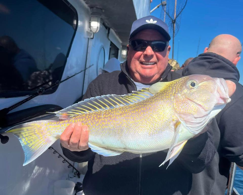Luis Barboza of Hamilton holds a golden tilefish he caught on the 125-foot Jamaica party boat. The fish weighed 10 pounds.