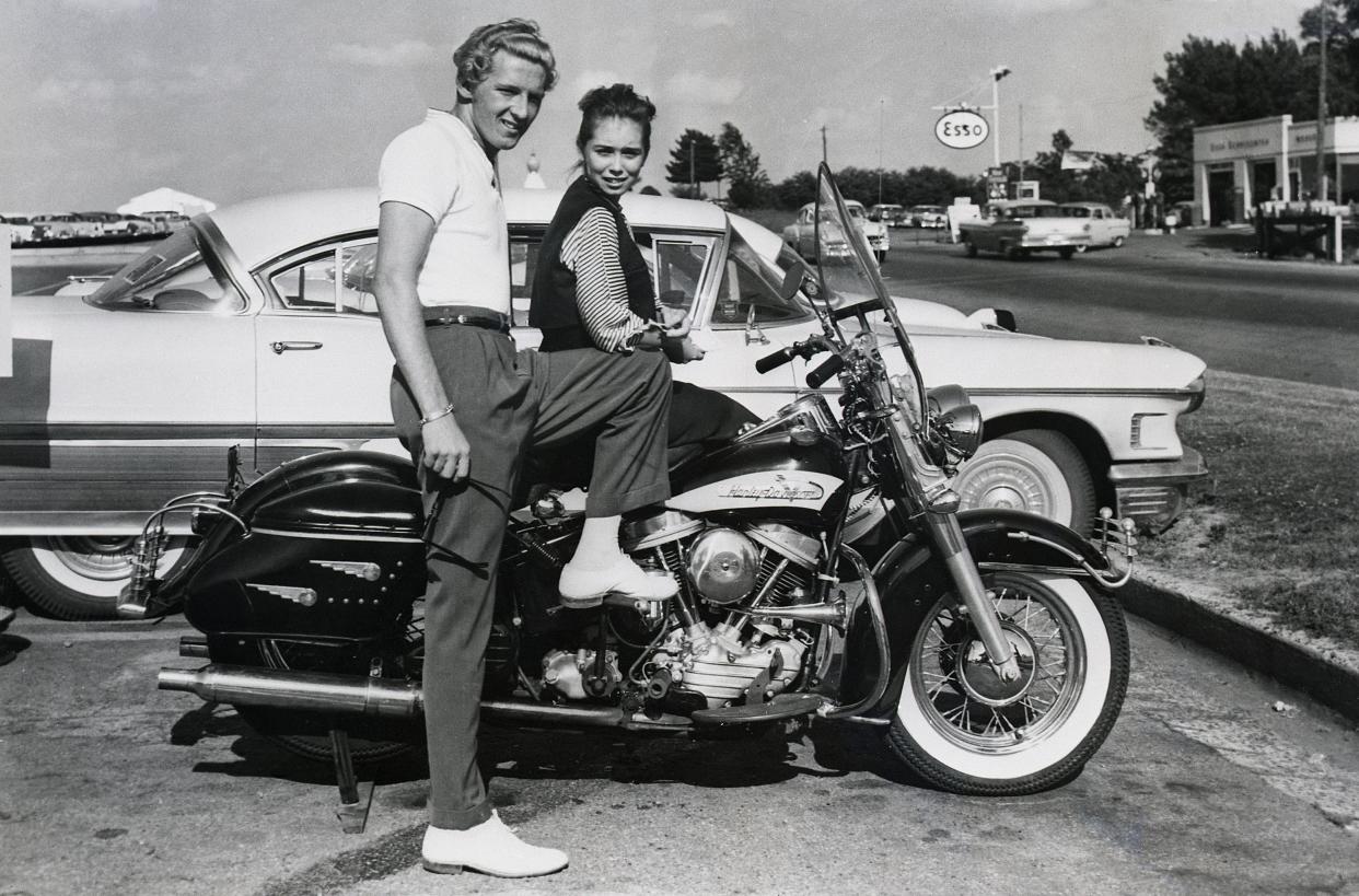 Memphis, Tennessee: Rock 'n' roll singer Jerry Lee Lewis and his 13-year-old wife, Myra, get set for a motorcycle ride here, June 14th, after the singer flew home from New York. His nightclub engagement in Manhattan was cut short.