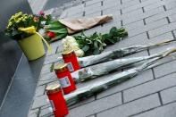 Flowers and candles are placed near the Midnight Shisha bar after a shooting in Hanau