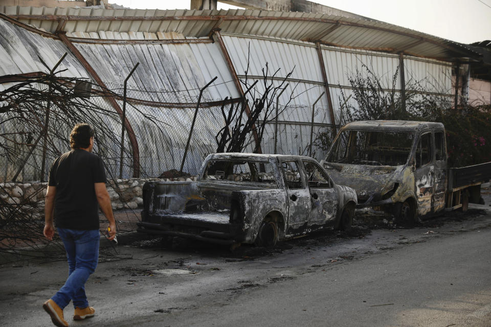 Burnt cars sit after a Tuesday's rocket firing from Gaza, in Sderot, southern Israel, Wednesday, Nov. 13, 2019. Gaza officials say new Israel airstrikes have killed a few militants. (AP Photo/Ariel Schalit)
