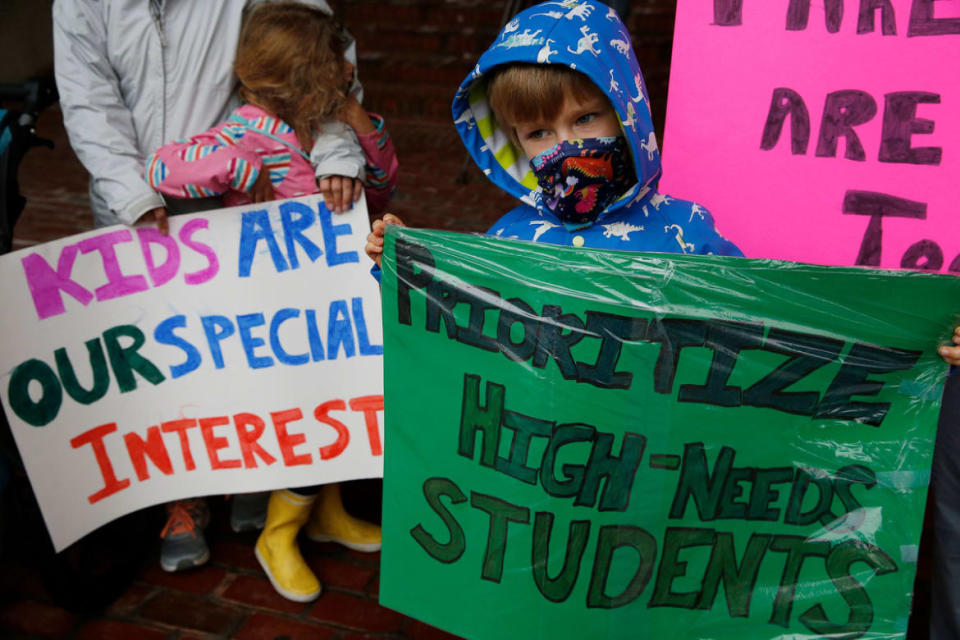 <div class="inline-image__caption"><p>A student holds a sign during a rally outside Boston City Hall demanding schools to reopen and prioritizing high-needs students for in-person learning in 2020.</p></div> <div class="inline-image__credit">Jessica Rinaldi/The Boston Globe via Getty</div>