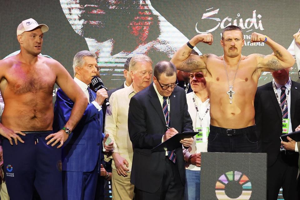 Fury (left) watches on as Usyk weighs in (Getty Images)