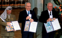 <p>PLO Chairman Yasser Arafat, Israeli Foreign Minister Shimon Peres and Israeli Prime Minister Yitzhak Rabin (from L to R) show their shared Nobel Peace Prize awards to the audience in the Oslo City Hall in Oslo in this December 10, 1994 file photo. REUTERS/Jerry Lampen/Files TPX IMAGES OF THE DAY – RTSPRM3 </p>