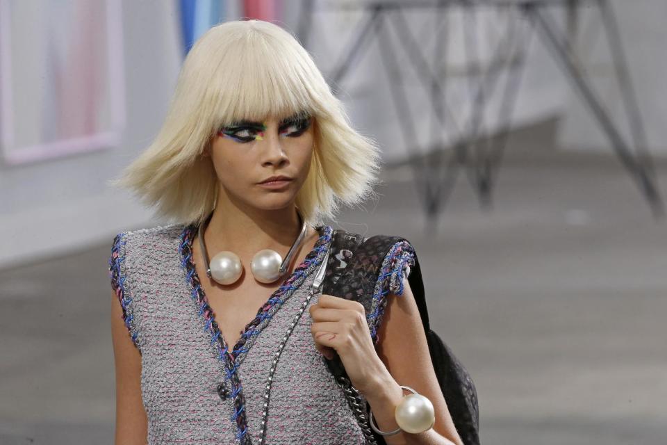 Model Cara Delevingne presents a creation as part of Chanel's ready-to-wear Spring/Summer 2014 fashion collection, presented Tuesday, Oct. 1, 2013 in Paris. (AP Photo/Jacques Brinon)
