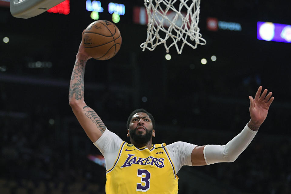 FILE - In this Tuesday, March 3, 2020, file photo, Los Angeles Lakers forward Anthony Davis shoots during the first half of an NBA basketball game against the Philadelphia 76ers in Los Angeles. Davis left his team’s scrimmage against the Orlando Magic on Saturday, July 25, 2020, after being poked in the right eye and is listed as day-to-day. (AP Photo/Mark J. Terrill, File)