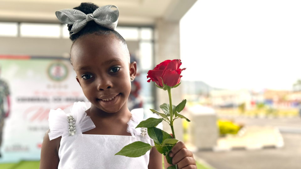 Royalty Ojeh, daughter of Nigeria Unconquered founder Bobby Ojeh, holding a flower