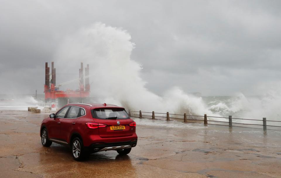 Large waves hit the harbour wall in Newhaven, East Sussex (Reuters)