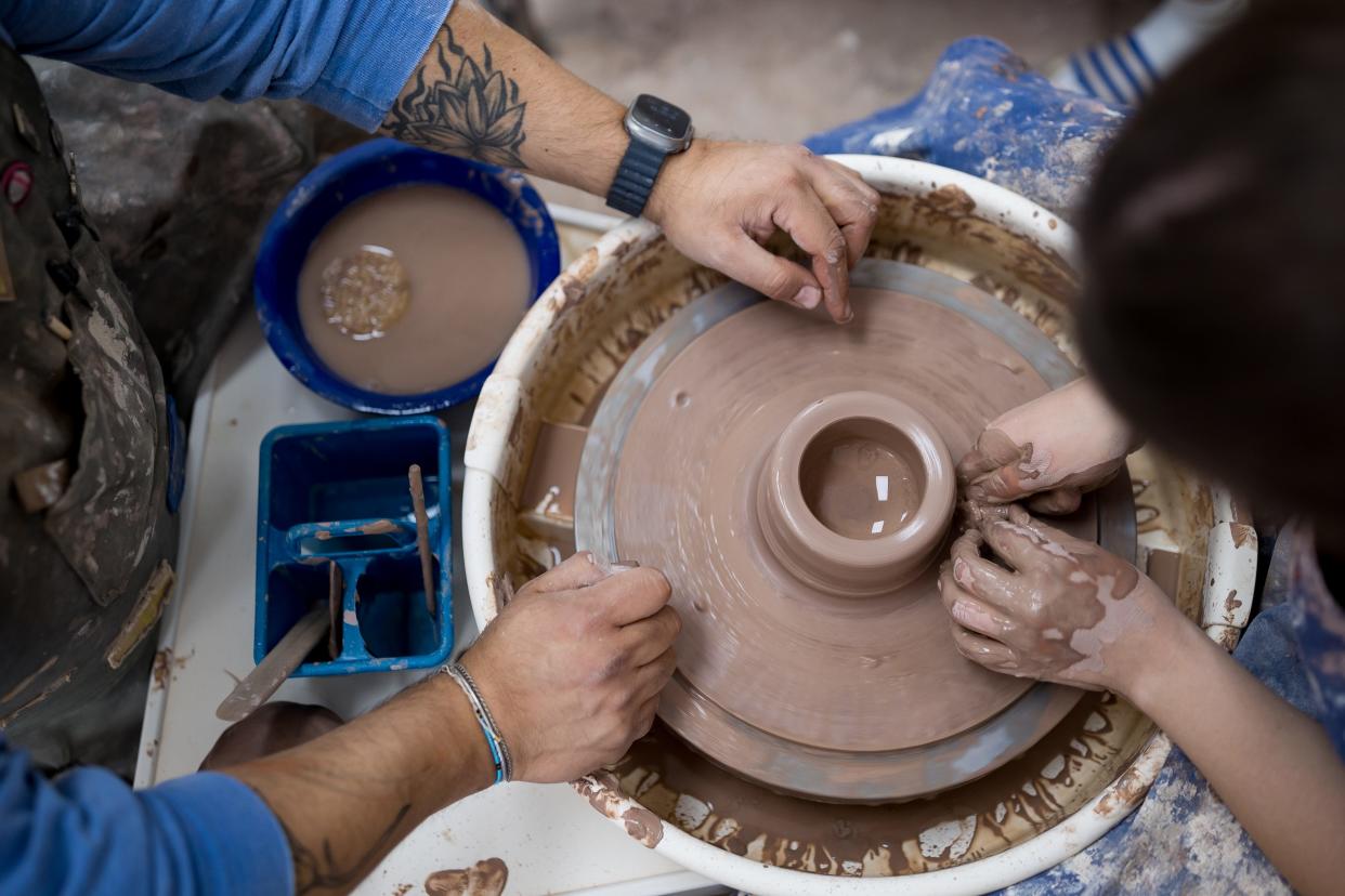 Philip John "PJ" Romero helps his student Cecilia Otero make bowls at his ceramics studio, PJ Romero Artworks, located at 120 S. Carolina Dr. in El Paso, TX, on Tuesday, June 18, 2024.