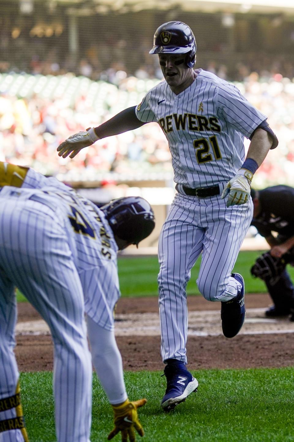 Milwaukee Brewers' Mark Canha is congratulated by William Contreras after hitting a home run during the third inning of a baseball game against the Philadelphia Phillies Sunday, Sept. 3, 2023, in Milwaukee. (AP Photo/Morry Gash)