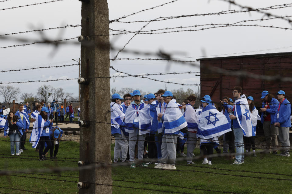 People participate in the annual 'March of the Living', a trek between two former Nazi-run death camps, in Oswiecim, Poland, Tuesday, April 18, 2023 to mourn victims of the Holocaust and celebrate the existence of the Jewish state. (AP Photo/Michal Dyjuk)