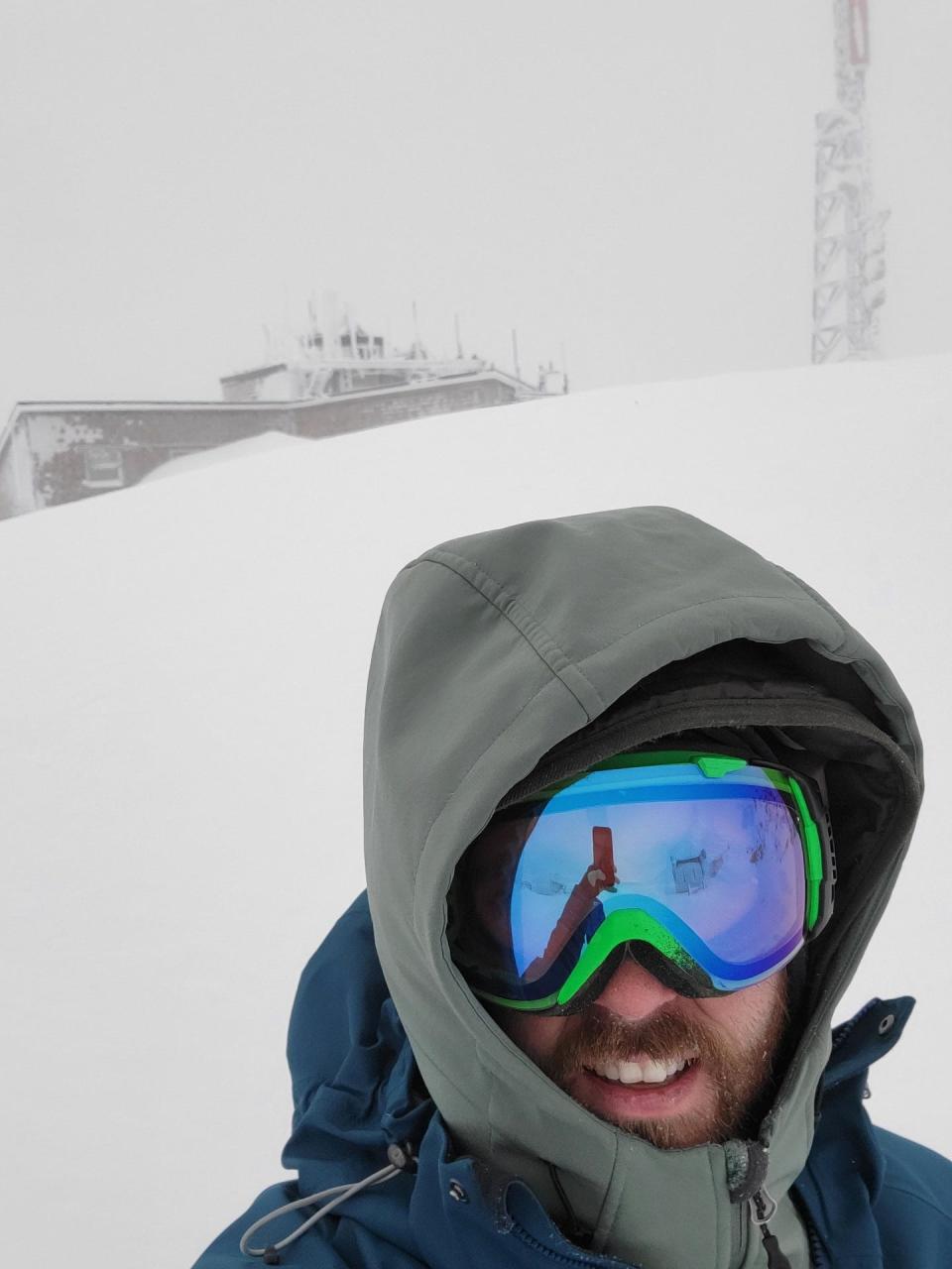 Jay Broccolo stands outside the Mount Washington Observatory on a wintry day. Special gear is required outdoors in winter, when extreme cold can lead to frostbite in minutes.