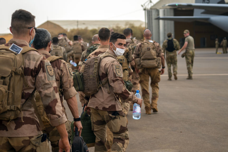 French Barkhane force soldiers who wrapped up a four-month tour of duty in the Sahel board a US Air Force C130 transport plane, leave their base in Gao, Mali Wednesday June 9, 2021. France has suspended joint military operations with Malian forces until the junta led by Col. Assimi Goita, who retook control of Mali's transitional government May 24, complies with international demands to restore civilian rule. (AP Photo/Jerome Delay)