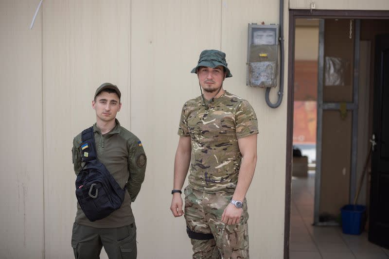 Oleksauk, a soldier who returned from Sievierodonetsk, poses for a picture with his friend in Slovyansk