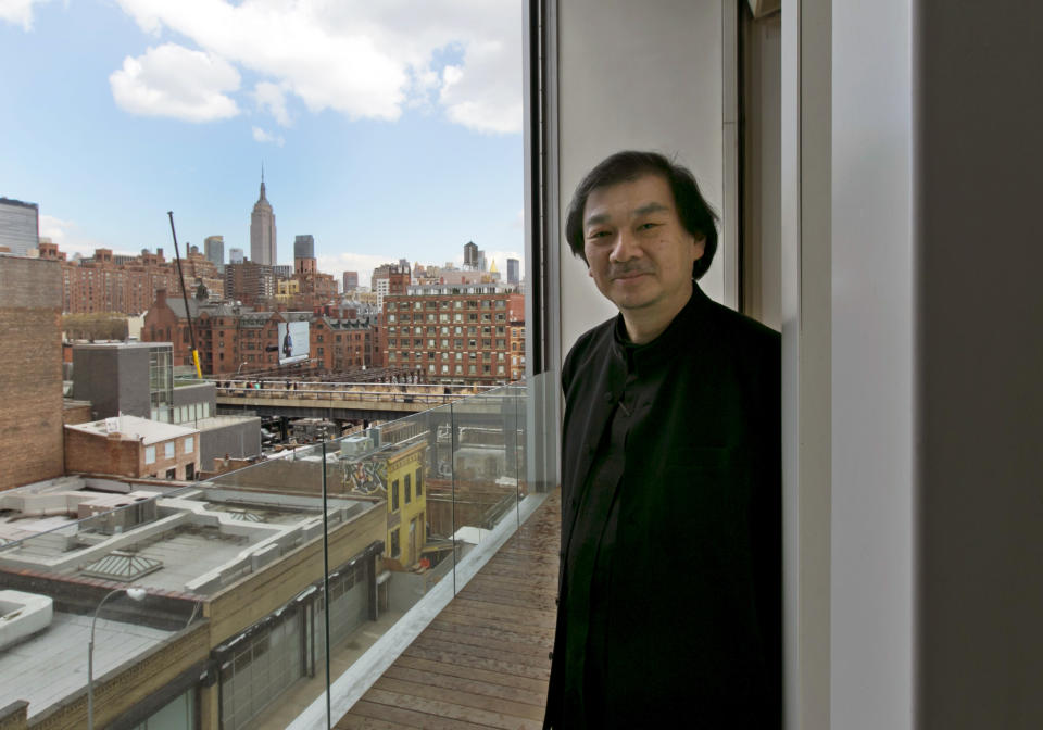 This March 20, 2014 photo shows Tokyo-born architect Shigeru Ban, 56, the recipient of the 2014 Pritzker Architecture Prize, standing on the balcony of an apartment in the Metal Shutter Houses he designed in New York. (AP Photo/Richard Drew)