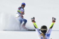 Switzerland's Lara Gut-Behrami celebrates winning the gold medal as United States' Mikaela Shiffrin comes in second in a women's giant slalom, at the alpine ski World Championships, in Cortina d'Ampezzo, Italy, Thursday, Feb. 18, 2021. (AP Photo/Marco Tacca)