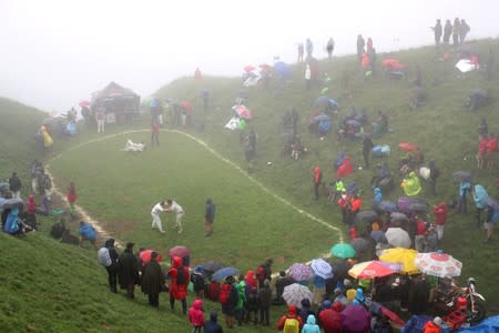 Spectators surround the arena as men fight during the "Hundstoa Ranggeln" at Hundstein mountain near the village of Maria Alm