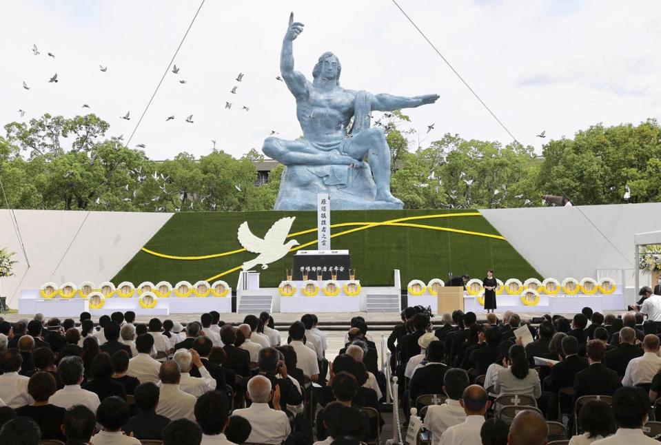 Doves fly over the Peace Statue during a ceremony commemorating the 77th anniversary of the bombing of the city at Nagasaki Peace Park (via REUTERS)