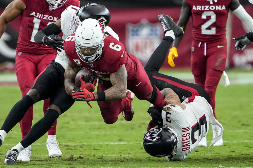 Arizona Cardinals running back James Conner (6) is hit by Atlanta Falcons safety Jessie Bates III (3) during the second half of an NFL football game, Sunday, Nov. 12, 2023, in Glendale, Ariz. (AP Photo/Matt York)