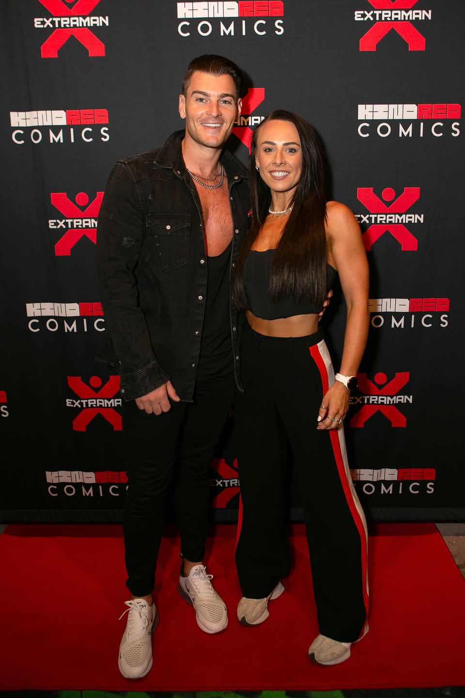 matt lapinskas and karina hind pose on the red carpet