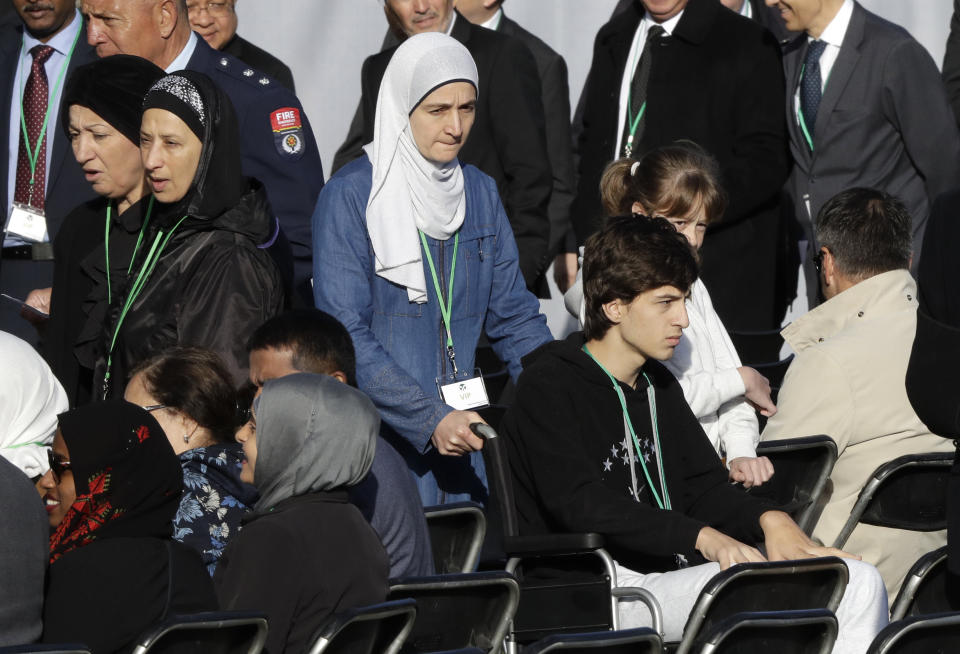 Mosque shooting survivor Zaid Mustafa, in wheelchair arrives with his mother to the National Remembrance Service in Hagley Park for the victims of the March 15 mosques terrorist attack in Christchurch, New Zealand, Friday, March 29, 2019. (AP Photo/Mark Baker)