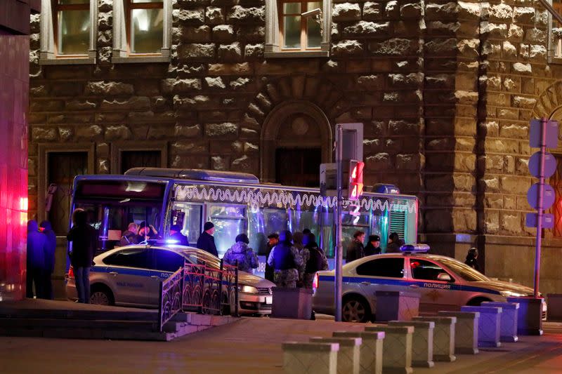 Security officers stand on the site of a shooting incident near the Federal Security Service (FSB) building in Moscow