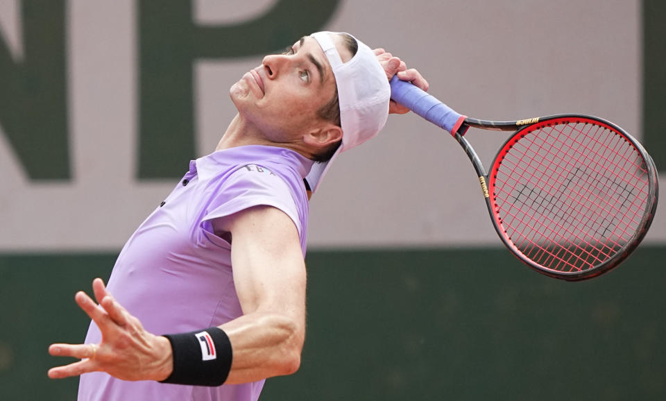 United States' John Isner serves to Serbia's Filip Krajinovic during their second round match on day four of the French Open tennis tournament at Roland Garros in Paris, France, Wednesday, June 2, 2021. (AP Photo/Michel Euler)