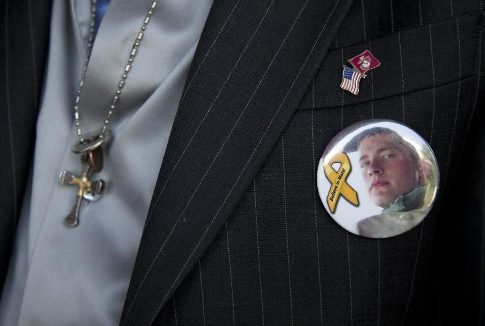 Keith Maupin wears a pin with an image of his son, Sgt. Matt Maupin, in Arlington, Va.,Tuesday, May 13, 2014. A man in Iraqi custody has confessed to killing Sgt. Matt Maupin whose remains were found in 2008. Sgt. Matt Maupin, of Batavia in southwestern Ohio, was captured when insurgents with rocket-propelled grenades and small arms ambushed his fuel convoy near Baghdad on April 9, 2004. (AP Photo)