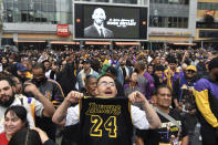 Gabriel Rivas, front, chants outside Staples Center at a memorial for Laker legend Kobe Bryant Sunday, Jan. 26, 2020, in Los Angeles. Bryant, the 18-time NBA All-Star who won five championships and became one of the greatest basketball players of his generation during a 20-year career with the Los Angeles Lakers, died in a helicopter crash Sunday. (AP Photo/Michael Owen Baker)