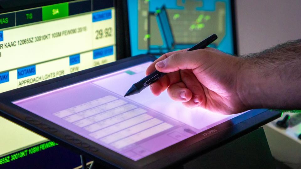 Ander Turueno Garcia scribbles a note onto a virtual pad during air traffic control training at Embry-Riddle Aeronautical University in May, 2024.