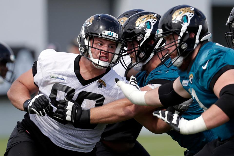 FILE - In this June 11, 2019, file photo, Jacksonville Jaguars defensive tackle Taven Bryan, left, rushes the offensive line during an NFL football practice, in Jacksonville, Fla. The defensive tackle and 2018 first-round draft pick is expected to be in the starting lineup again Thursday night, Aug. 29, 2019,  when the Jaguars (0-3) host the Atlanta Falcons (0-4) in the preseason finale for both teams. (AP Photo/John Raoux, File)