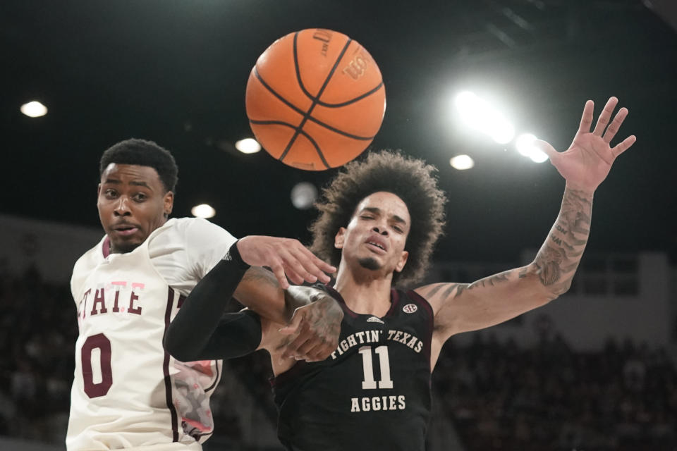 Mississippi State forward D.J. Jeffries (0) and Texas A&M forward Andersson Garcia (11) link arms as they reach for a rebound during the first half of an NCAA college basketball game in Starkville, Miss., Saturday, Feb. 25, 2023. (AP Photo/Rogelio V. Solis)