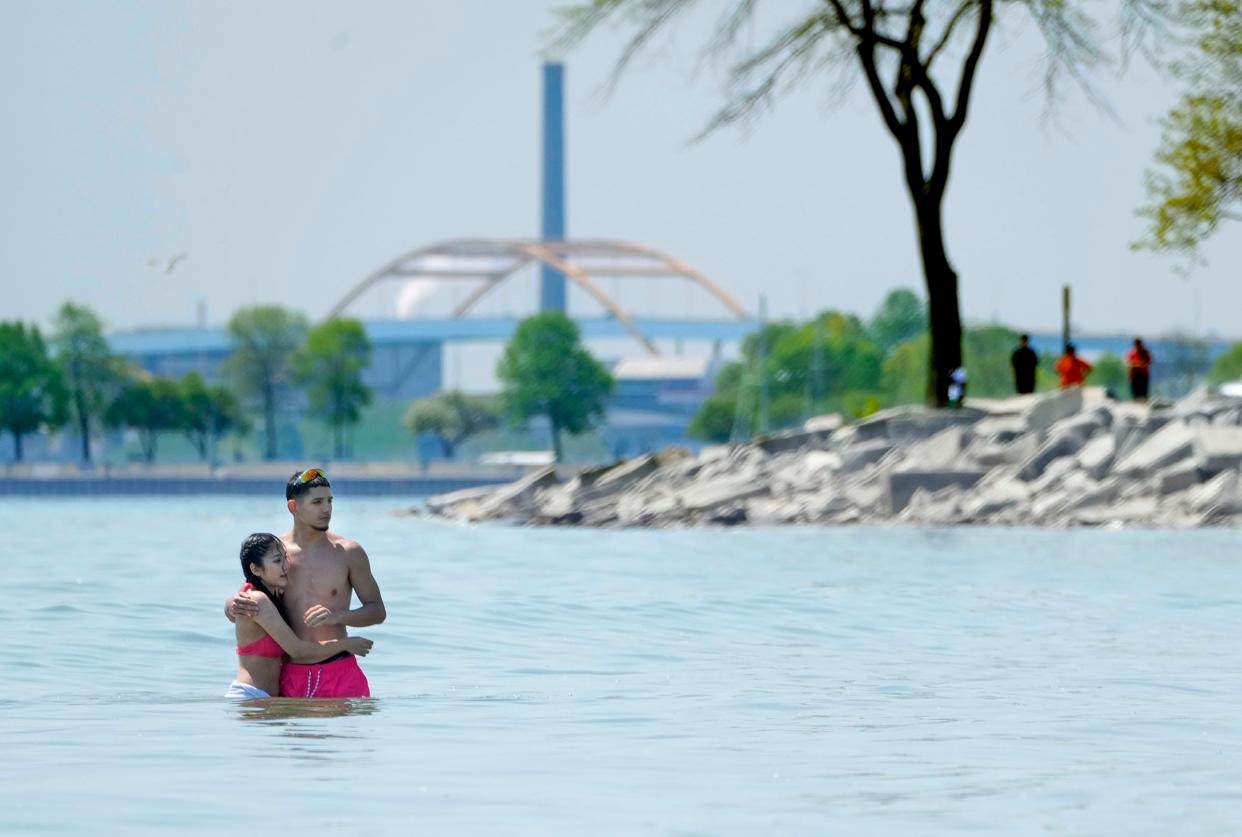 Nahomi Mendoza (left), and her boyfriend Jenuel Martinez, of Milwaukee, got for a swim at Bradford Beach on North Lincoln Memorial Drive in Milwaukee on Thursday, June 1, 2023.