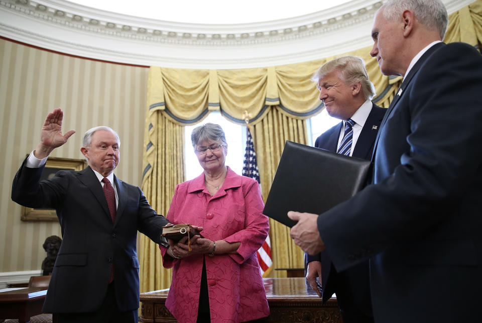 U.S. President Donald Trump (2nd R) watches as Jeff Sessions (L) is sworn in as the new U.S. Attorney General by U.S. Vice President Mike Pence (R) in the Oval Office of the White House February 9, 2017 in Washington, D.C. (Photo by Win McNamee/Getty Images)