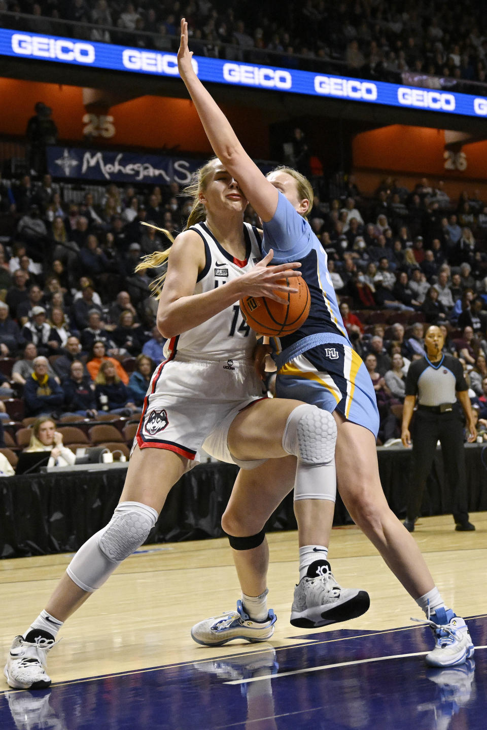 Connecticut's Dorka Juhasz, left, drives to the basket as Marquette's Liza Karlen defends during the first half of an NCAA college basketball game in the semifinals of the Big East Conference tournament at Mohegan Sun Arena, Sunday, March 5, 2023, in Uncasville, Conn. (AP Photo/Jessica Hill)