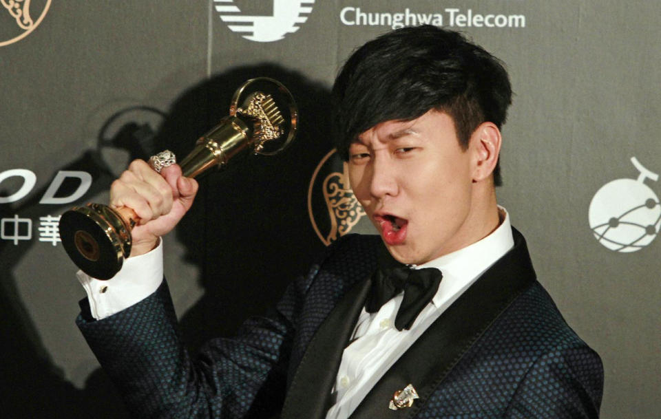 Singapore singer JJ Lin holds his award for the Best Male Mandarin Singer at the 27th Golden Melody Awards in Taipei, Taiwan, Saturday, June 25, 2016. (AP Photo/Chiang Ying-ying)