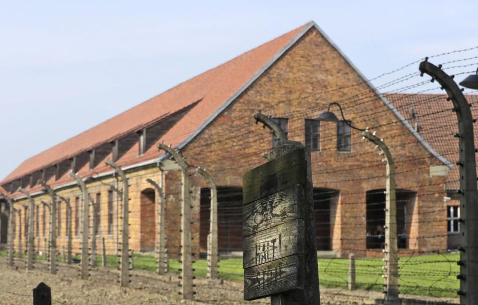 A sign reading “stop” in German and Polish is seen in the former Nazi German death camp of Auschwitz in Oswiecim, Poland, Friday, July 29, 2016. (AP Photo/Gregorio Borgia)