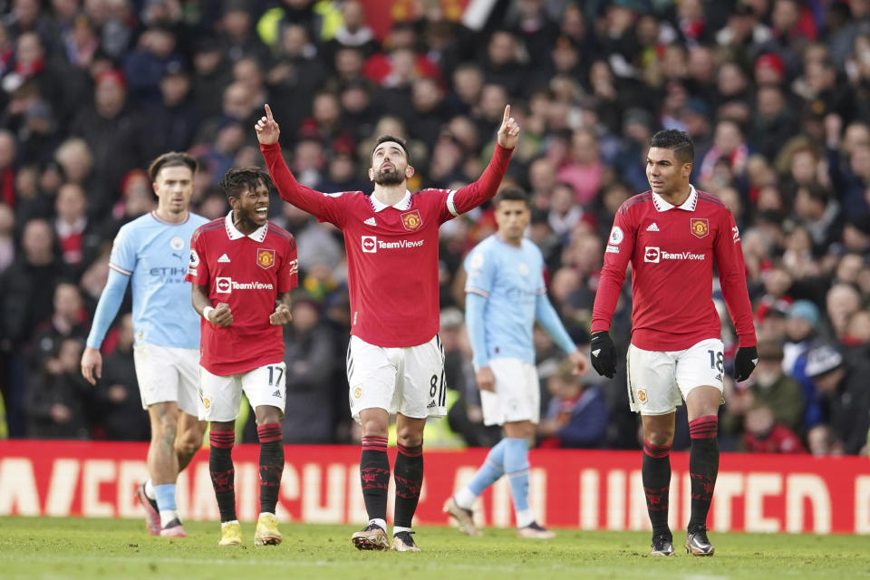Manchester United's Bruno Fernandes celebrates after scoring his side's first goal during the English Premier League soccer match between Manchester United and Manchester City at Old Trafford in Manchester, England, Saturday, Jan. 14, 2023. (AP Photo/Dave Thompson)