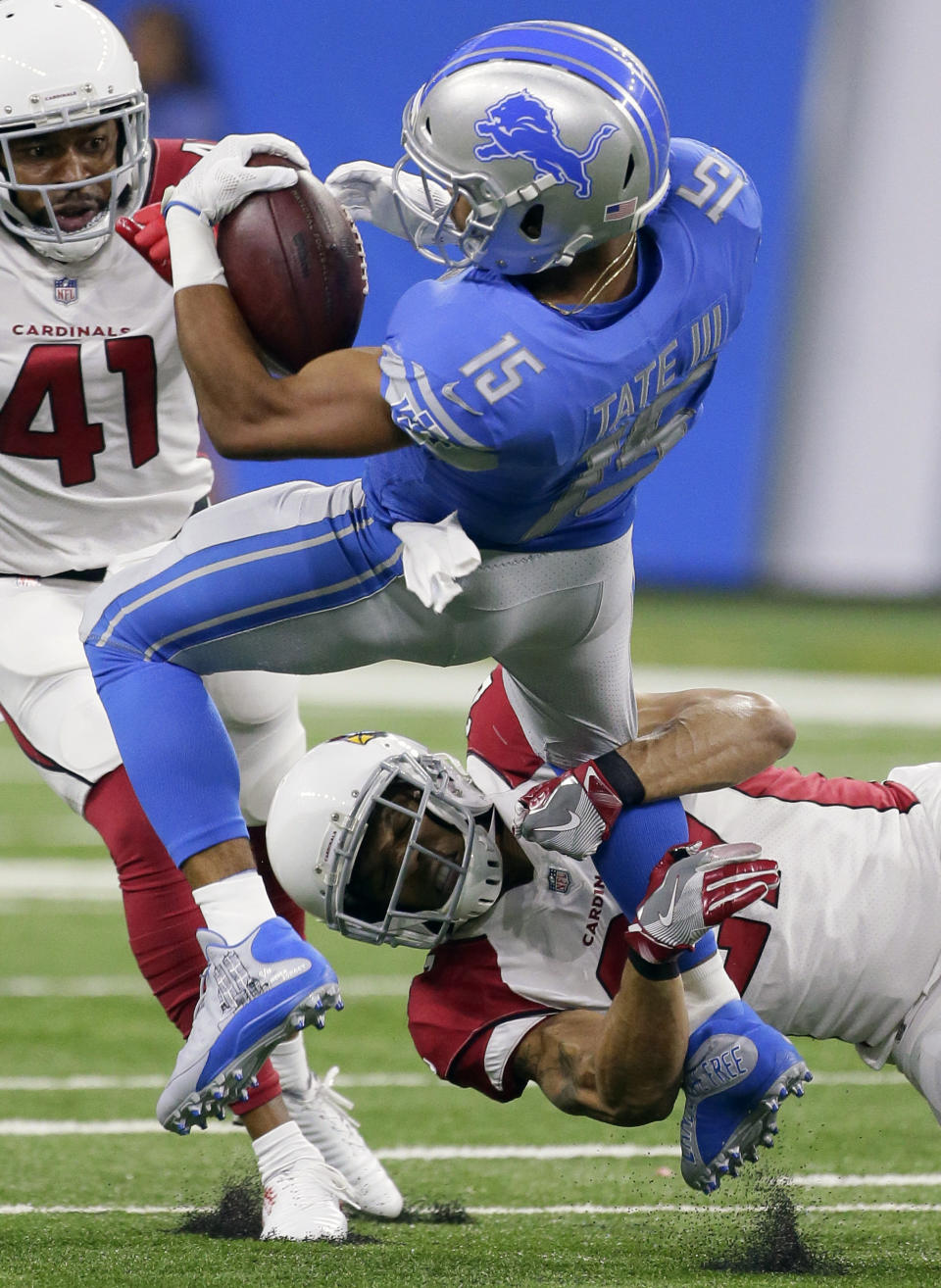 <p>Detroit Lions wide receiver Golden Tate (15) is brought down by Arizona Cardinals defensive back Tyvon Branch (27) as Antoine Bethea (41) looks on during the first half of an NFL football game in Detroit, Sunday, Sept. 10, 2017. (AP Photo/Jose Juarez) </p>