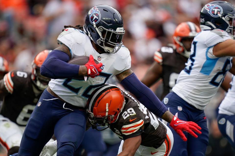 Tennessee Titans running back Derrick Henry (22) evades Cleveland Browns cornerback Cameron Mitchell (29) during the third quarter in Cleveland, Ohio, Sunday, Sept. 24, 2023.