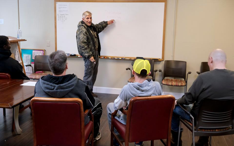 Feb 5, 2024; Tuscaloosa, Alabama, USA; Jim Jones, a certified recovery support specialist, conducts a meeting at Phoenix House in Tuscaloosa for men who are in the program.