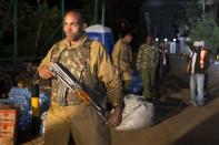 A police officer walks towards the edge of a security perimeter put into place a distance from the Westgate Shopping Centre in Nairobi, in the early hours of the morning during a standoff operation between Kenyan security forces and gunmen inside the building, September 24, 2013. REUTERS/Siegfried Modola