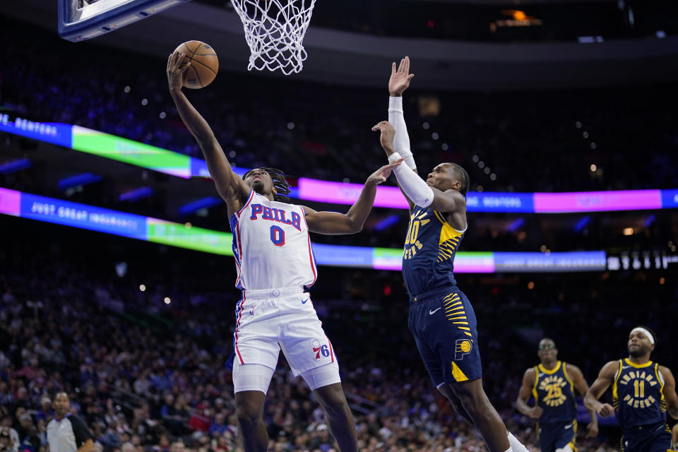 Philadelphia 76ers' Tyrese Maxey, left, goes up for a shot past Indiana Pacers' Bennedict Mathurin during the first half of an NBA basketball game, Sunday, Nov. 12, 2023, in Philadelphia. (AP Photo/Matt Slocum)