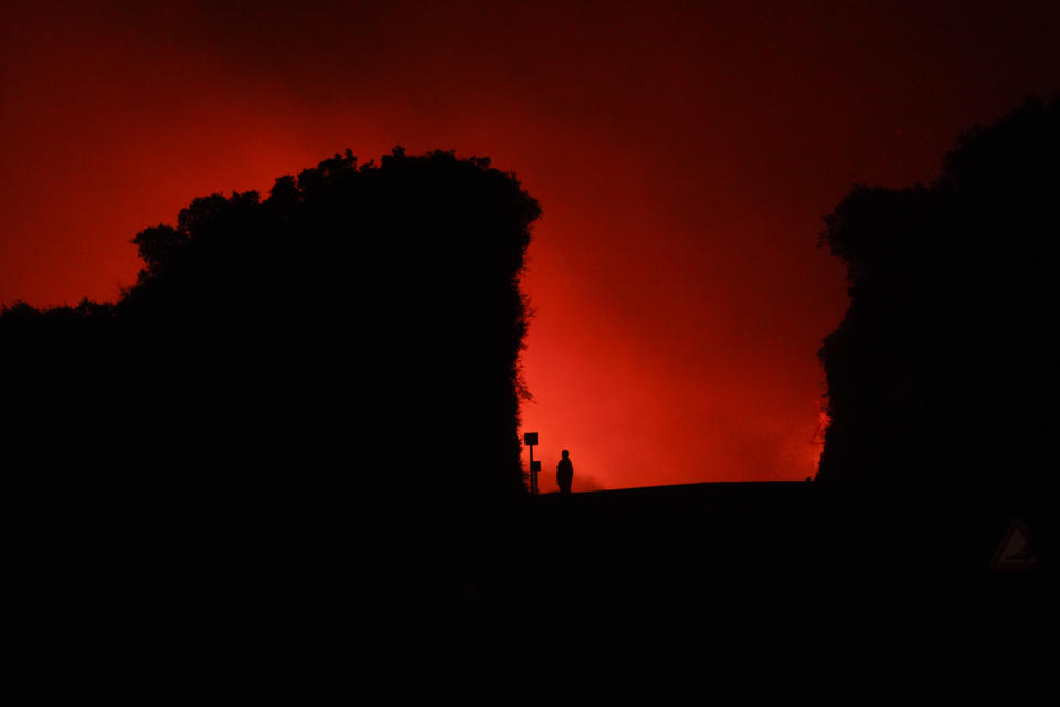 Fires rage through the countryside in Cuglieri, near Oristano, Sardinia, Italy, early Sunday, July 25, 2021. Hundreds of people were evacuated from their homes in many small towns in the province of Oristano, Sardinia, after raging fires burst in the areas of Montiferru and Bonarcado. (Alessandro Tocco/LaPresse via AP)