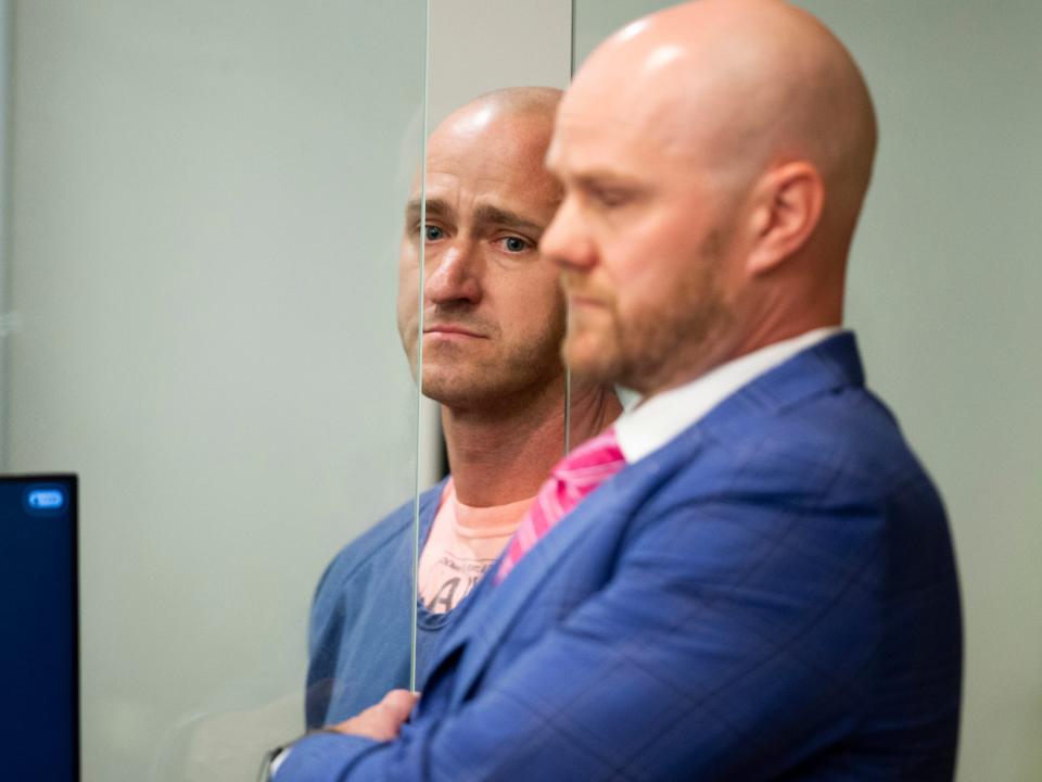 man stands during arraignment